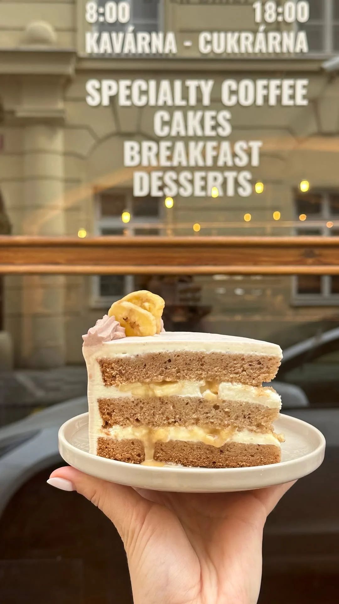 Cake slice held in front of the café window
